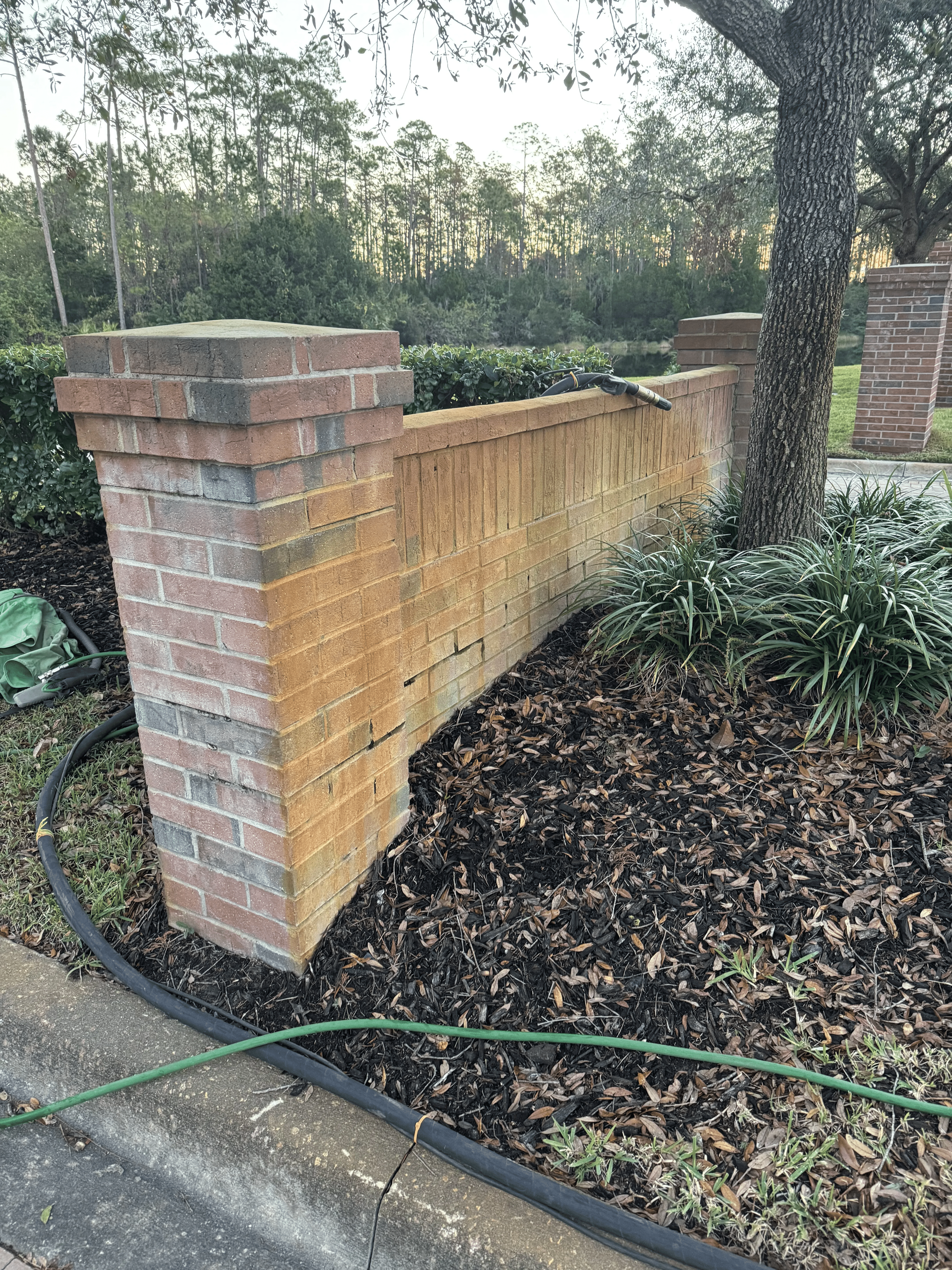 Brick column and wall with stains before surface cleaning