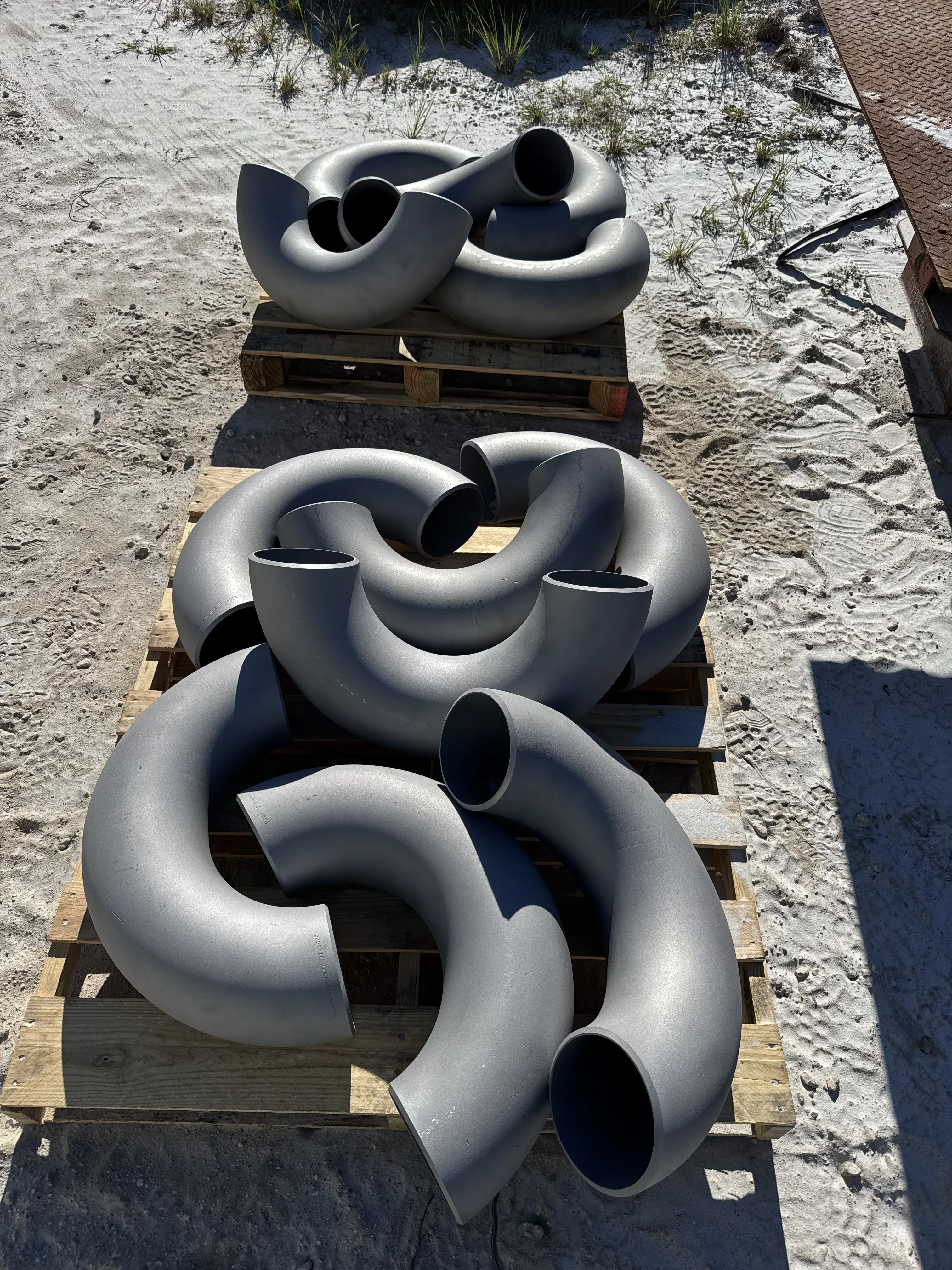 Industrial pipe fittings after blasting removed worn coating
