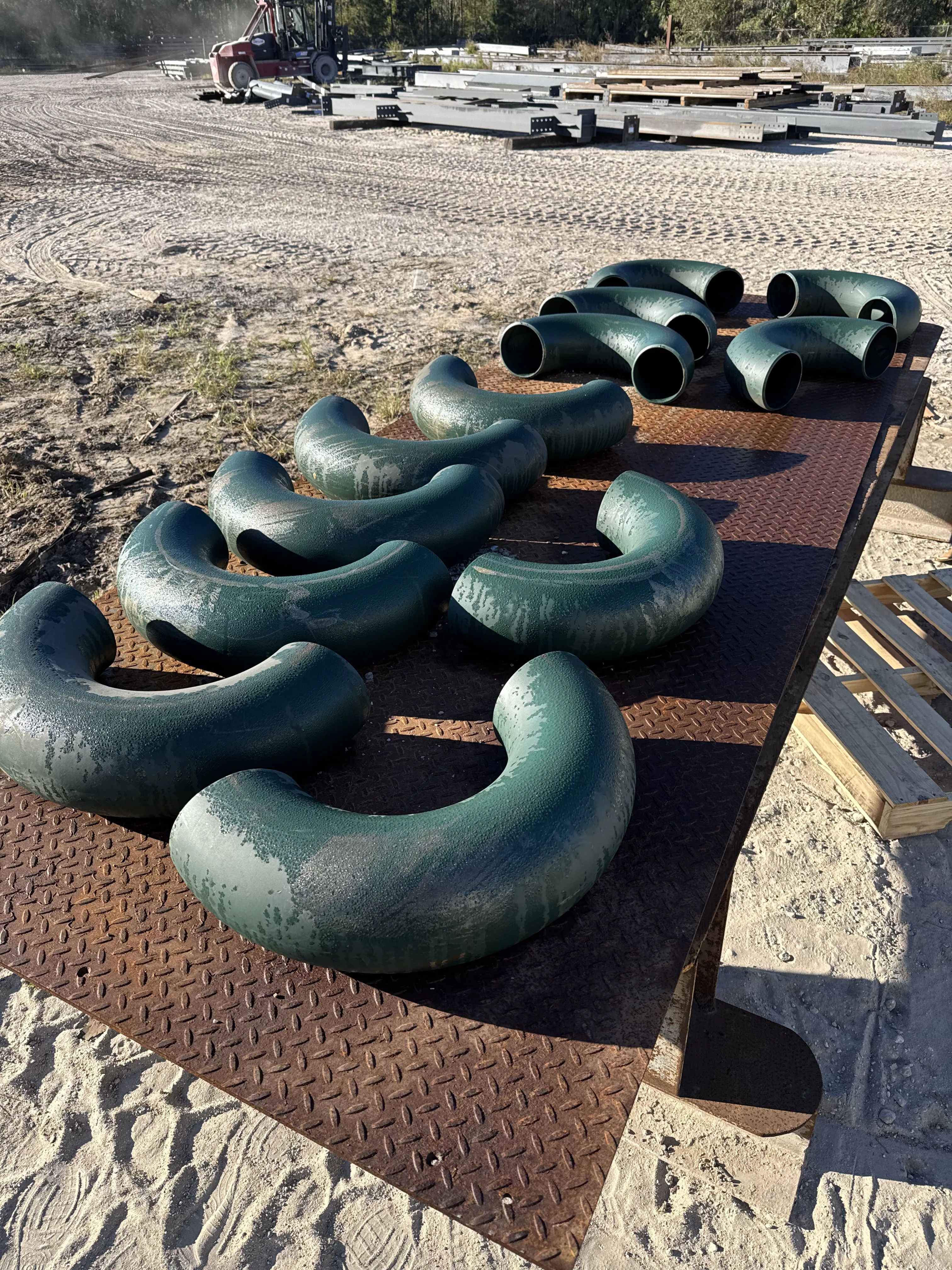 Industrial pipe fittings with worn coating before surface blasting
