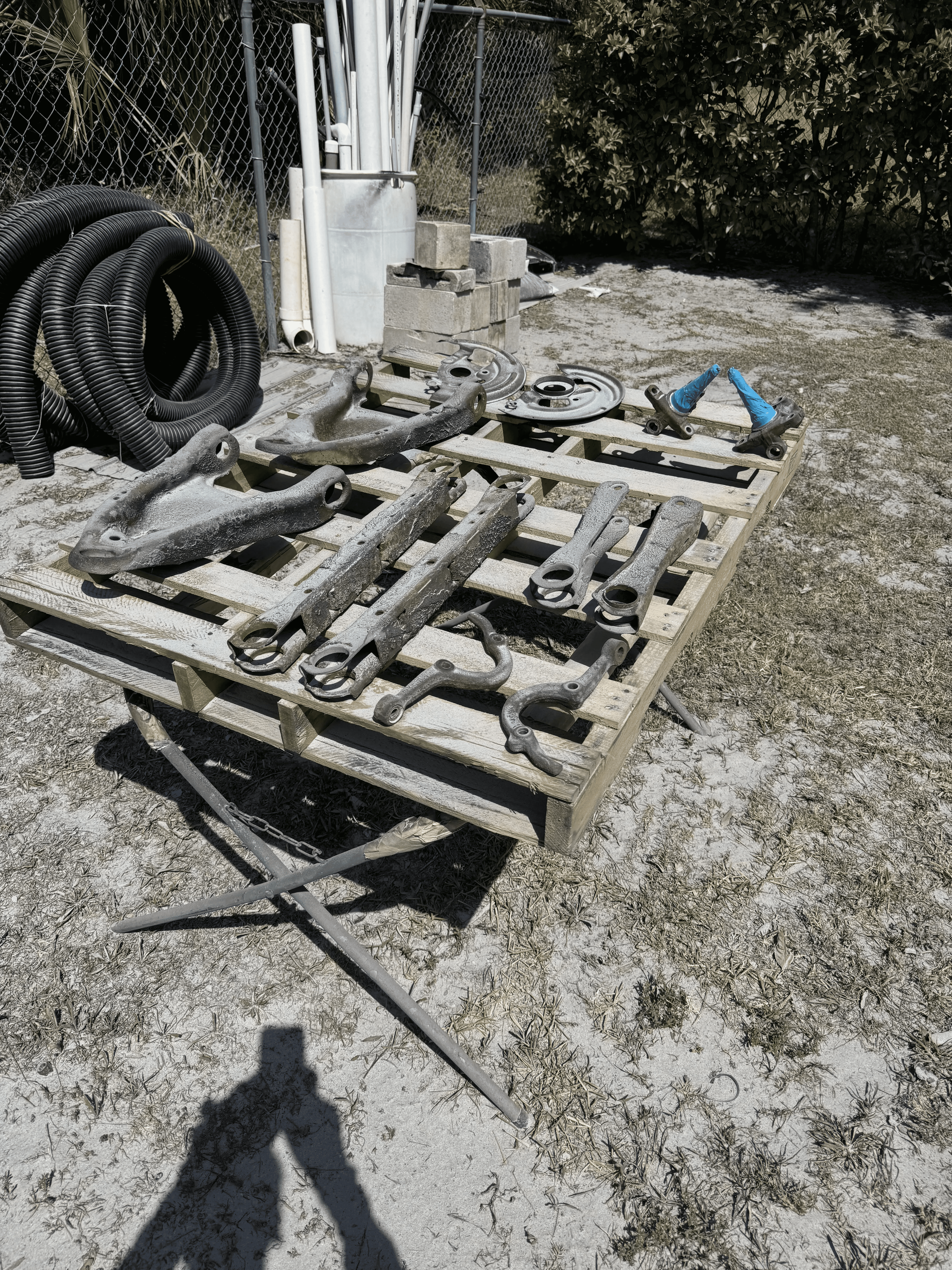 Automotive metal parts with rust and buildup before blasting