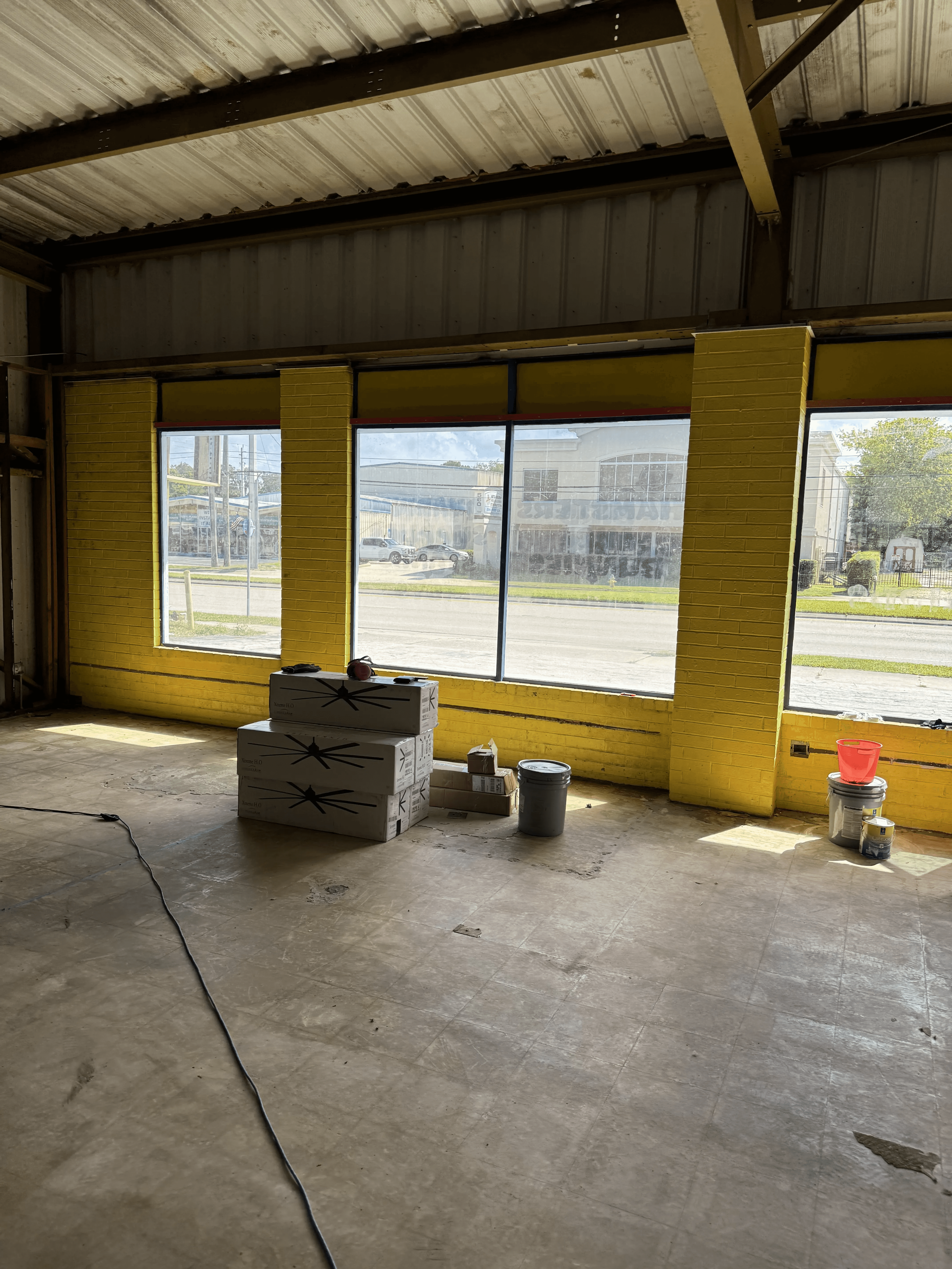 Interior brick and block wall with yellow paint before blasting